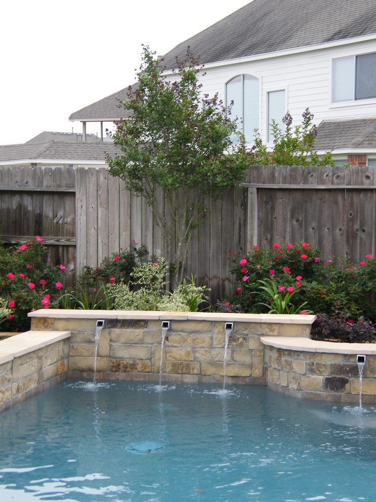 Pool fountain - mid-sized transitional backyard tile and custom-shaped pool fountain idea in Houston
