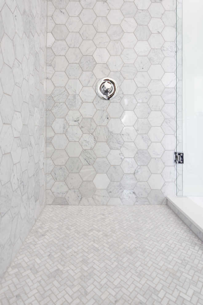 This is an example of a large contemporary master bathroom in Toronto with shaker cabinets, white cabinets, a freestanding tub, a corner shower, a one-piece toilet, white tile, marble, white walls, marble floors, an undermount sink, engineered quartz benchtops, white floor and a hinged shower door.