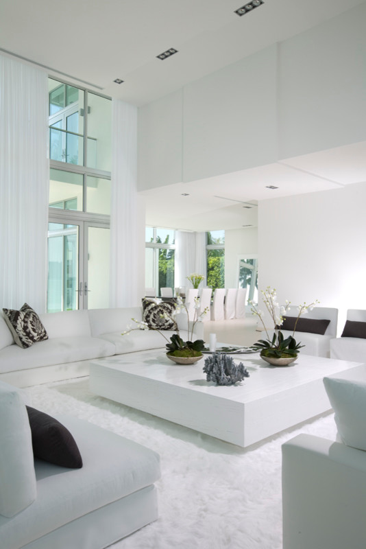 This is an example of a large contemporary formal loft-style living room in Miami with white walls, porcelain floors and no tv.