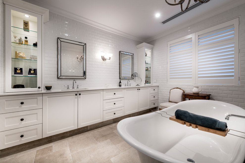 Inspiration for a large traditional master bathroom in Perth with recessed-panel cabinets, white cabinets, a freestanding tub, white tile, subway tile, engineered quartz benchtops and white benchtops.