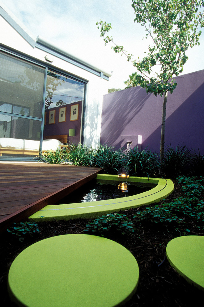 This is an example of a small contemporary courtyard patio in Perth with a water feature and decking.