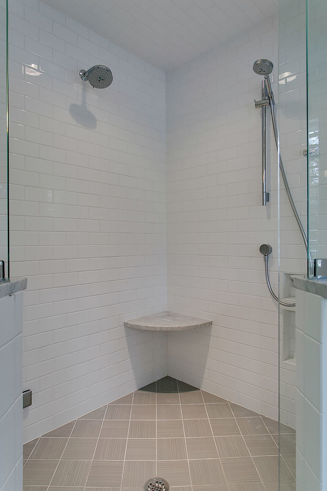 Freestanding bathtub - transitional gray tile ceramic tile freestanding bathtub idea in Raleigh with flat-panel cabinets, white cabinets, an undermount sink and marble countertops