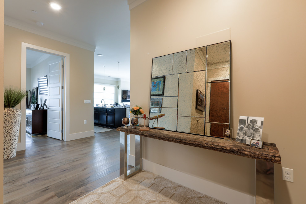 This is an example of a mid-sized transitional foyer in Denver with beige walls, medium hardwood floors, a single front door, a white front door and brown floor.