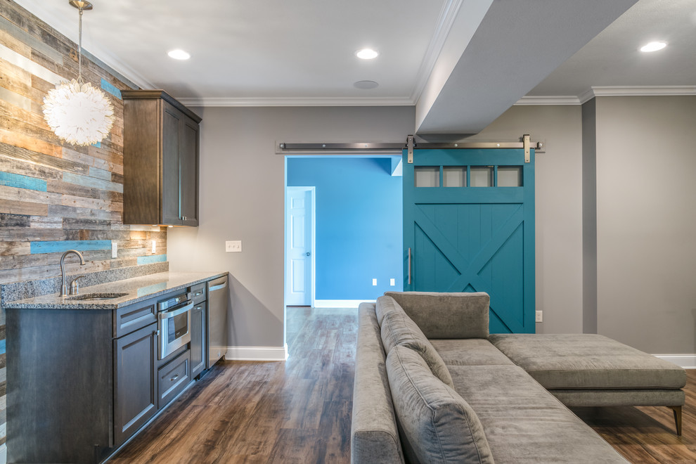 Inspiration for a mid-sized transitional walk-out vinyl floor and brown floor basement remodel with gray walls