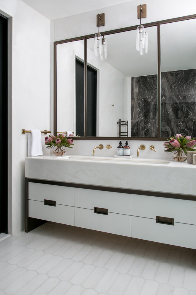 Photo of a large transitional master bathroom in New York with flat-panel cabinets, white cabinets, a freestanding tub, a double shower, a wall-mount toilet, beige tile, marble, white walls, marble floors, an undermount sink, onyx benchtops, beige floor and a hinged shower door.