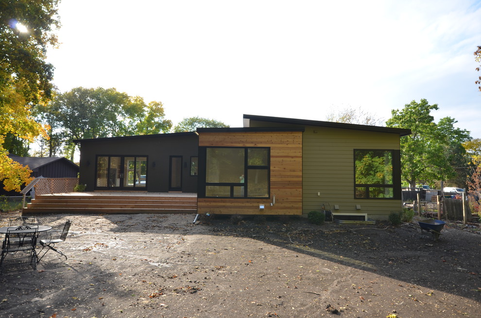 This is an example of a modern one-storey green exterior in Minneapolis with mixed siding.