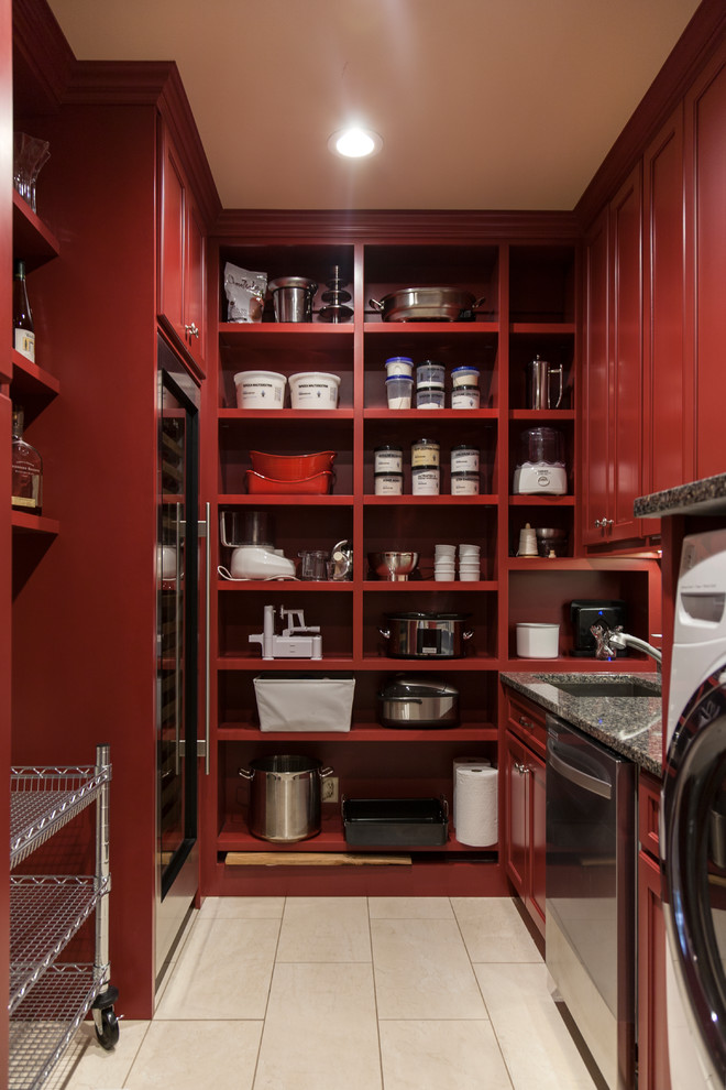 This is an example of a mid-sized transitional u-shaped utility room in St Louis with an undermount sink, recessed-panel cabinets, red cabinets, granite benchtops, beige walls, porcelain floors, a side-by-side washer and dryer, beige floor and black benchtop.