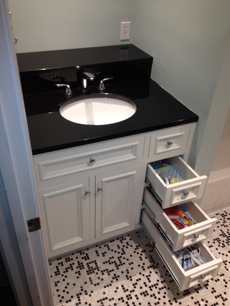 Small country kids bathroom in Boston with raised-panel cabinets, white cabinets, black and white tile, ceramic tile, an undermount sink and granite benchtops.