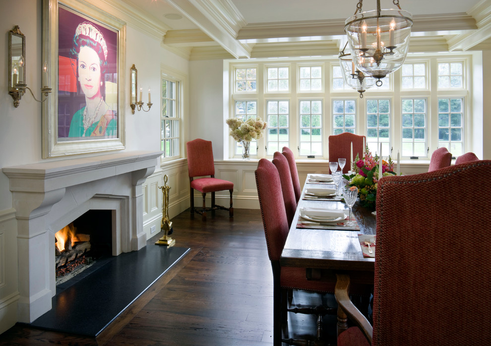 Traditional dining room in Boston with white walls, dark hardwood floors and a standard fireplace.