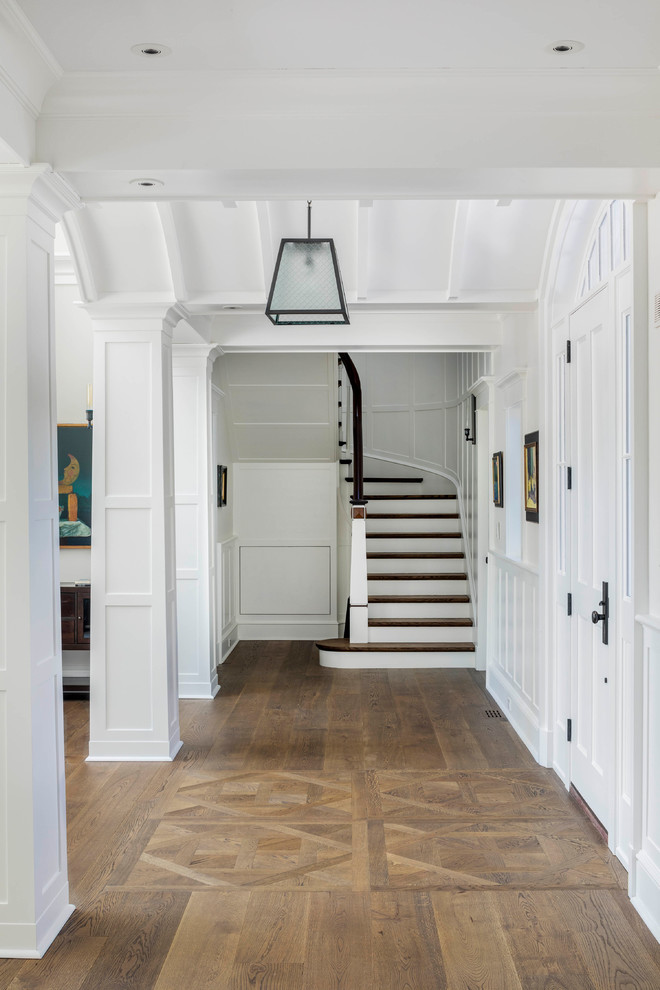 Hallway - large traditional medium tone wood floor and brown floor hallway idea in Boston with gray walls