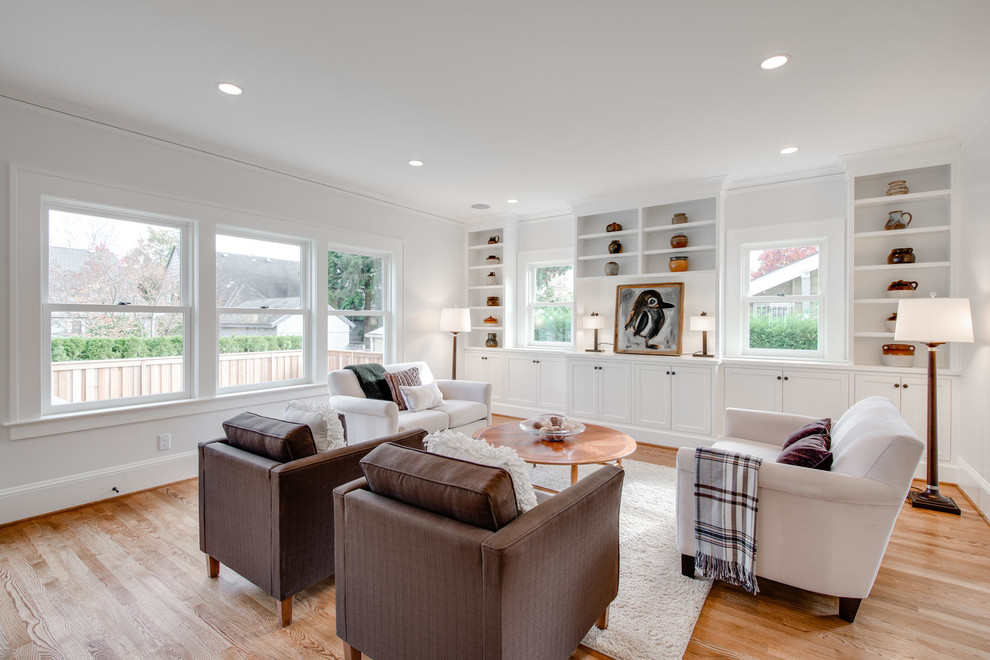 Transitional family room in Portland with white walls, medium hardwood floors, no fireplace and no tv.