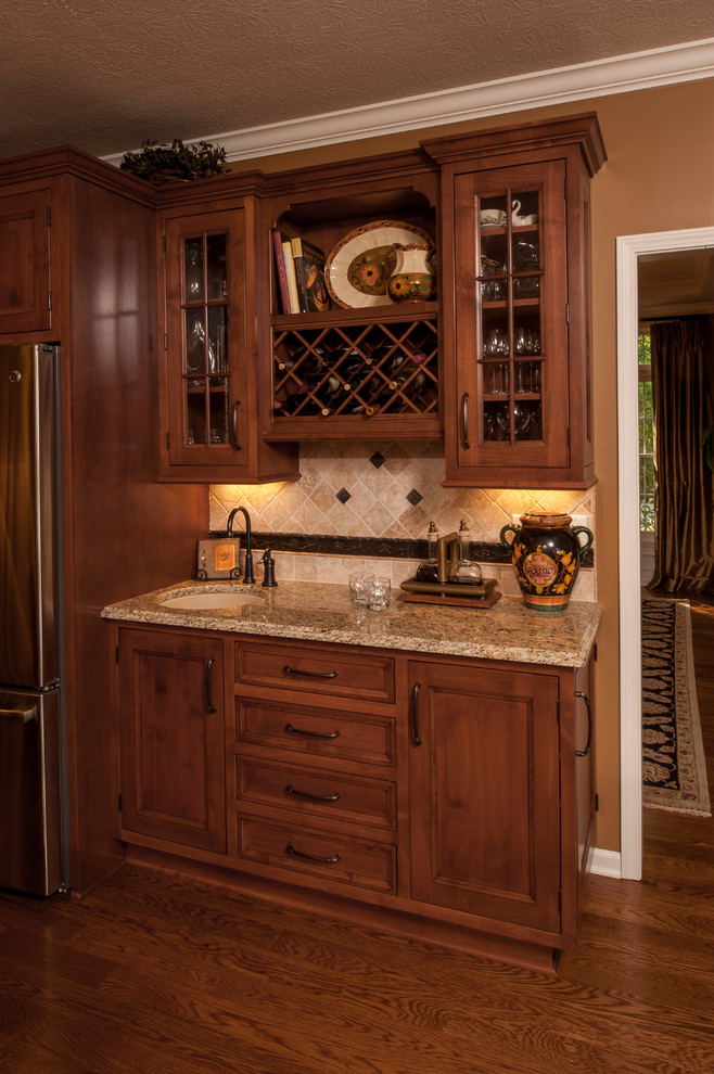 Traditional eat-in kitchen in Indianapolis with medium wood cabinets and with island.