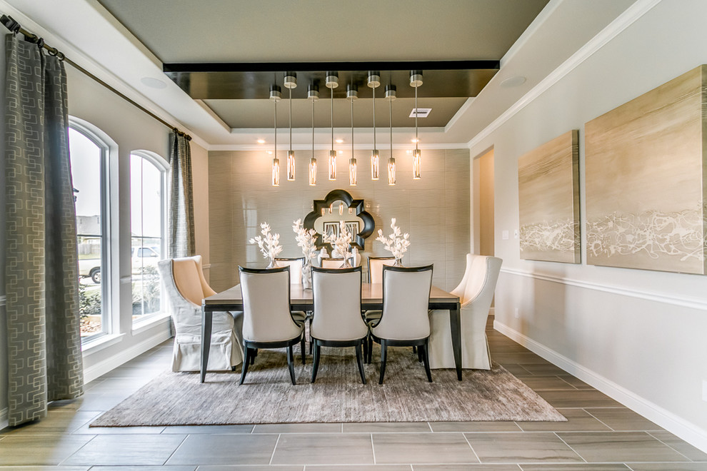 Photo of a transitional separate dining room in Houston with grey walls, no fireplace and grey floor.