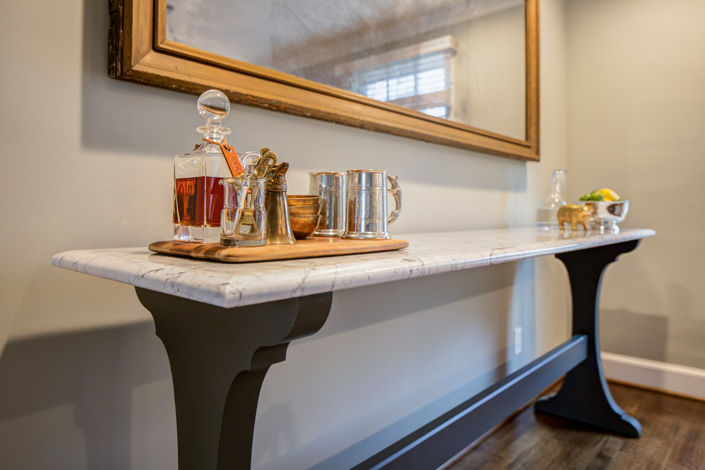 Inspiration for a transitional dark wood floor kitchen remodel with soapstone countertops, white backsplash and an island