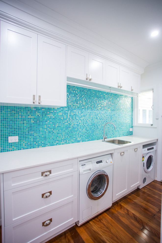 Design ideas for a mid-sized beach style single-wall dedicated laundry room in Brisbane.