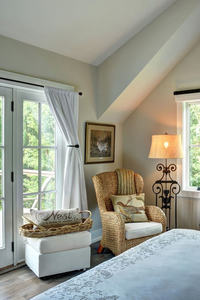Design ideas for a large country guest bedroom in Burlington with beige walls and light hardwood floors.