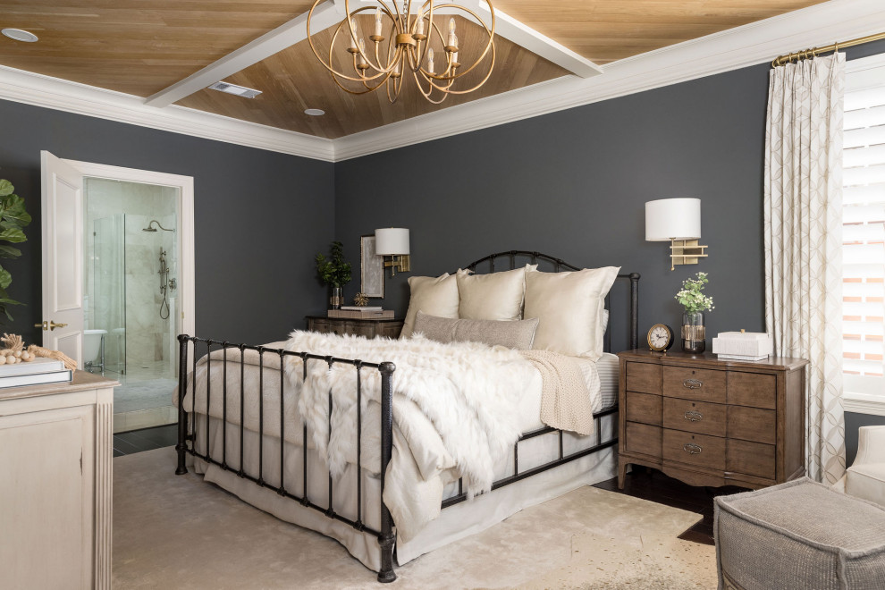 Mid-sized traditional master bedroom in Houston with wood.