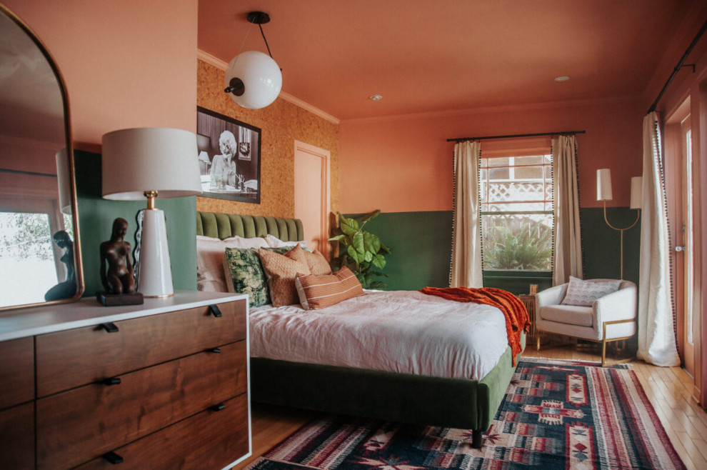 Inspiration for a midcentury master bedroom in Los Angeles with pink walls and light hardwood floors.