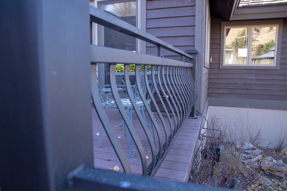 Example of a large mountain style backyard deck design with no cover