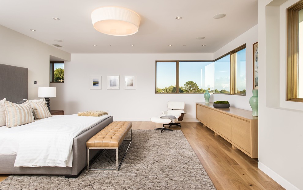 Large retro master bedroom in Los Angeles with white walls, light hardwood flooring and no fireplace.