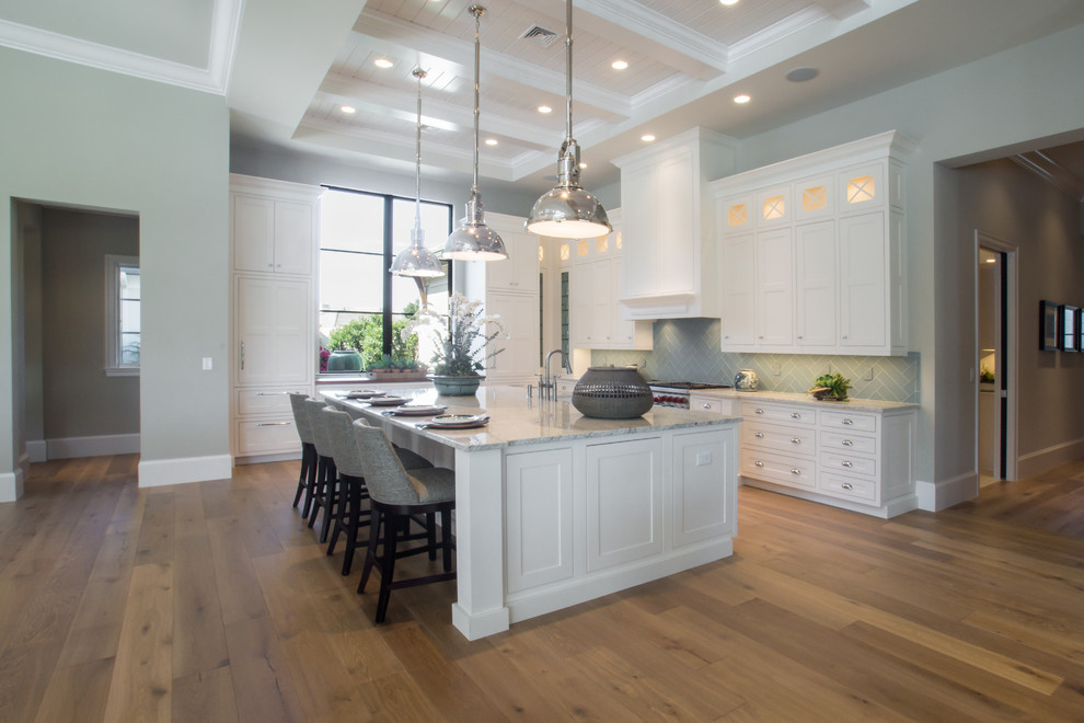 Inspiration for a large transitional l-shaped eat-in kitchen remodel in Miami with shaker cabinets, white cabinets, granite countertops, green backsplash and an island