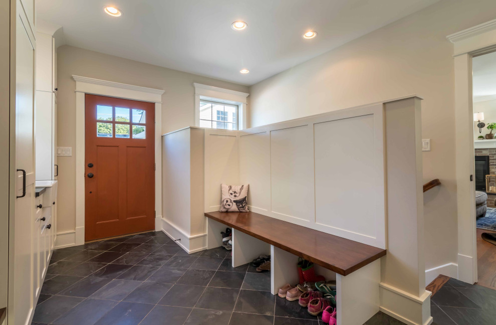 Photo of a mid-sized country mudroom in Chicago with beige walls, ceramic floors, a single front door, a brown front door, grey floor, wallpaper and planked wall panelling.