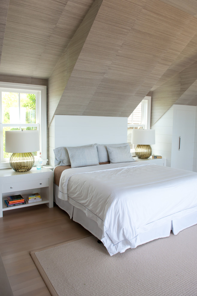 Contemporary bedroom in Boston with white walls and light hardwood floors.