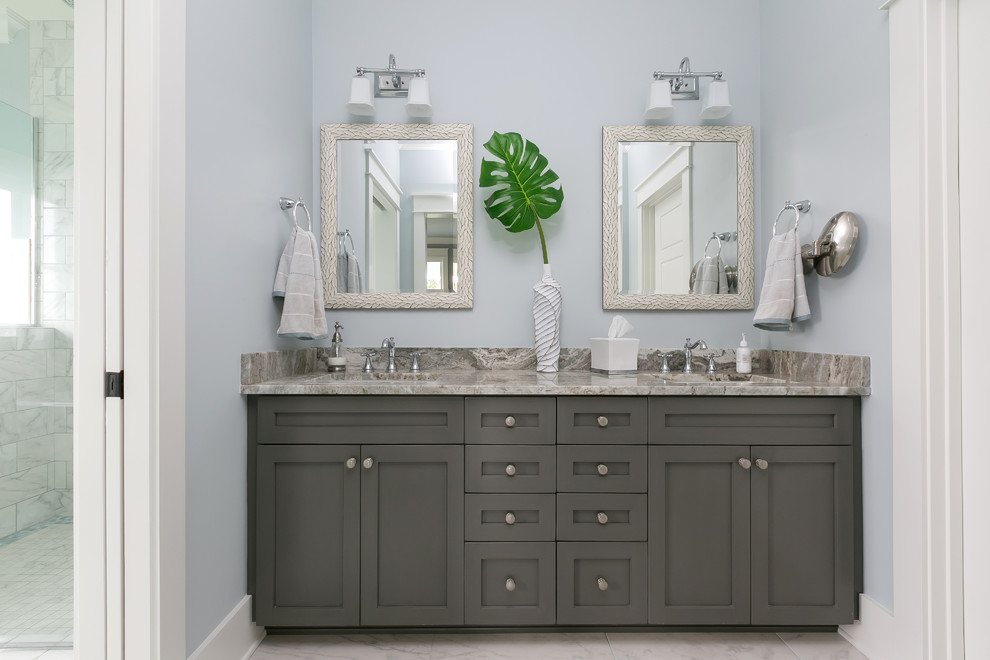 Photo of a large beach style master bathroom in Charleston with shaker cabinets, brown cabinets, grey walls, porcelain floors, an undermount sink and brown floor.