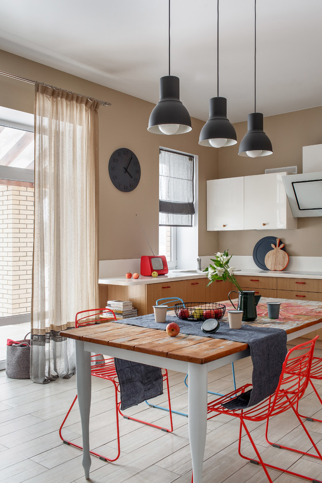 This is an example of a mid-sized eclectic l-shaped eat-in kitchen in Other with medium wood cabinets, white splashback, ceramic floors, no island, beige floor, white benchtop, a drop-in sink and flat-panel cabinets.