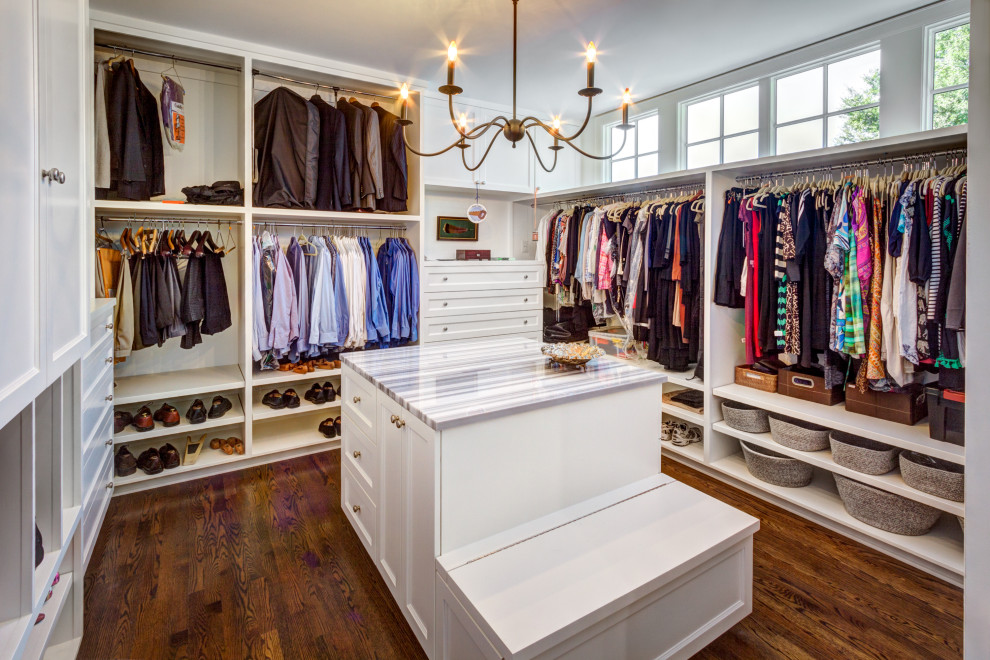 Inspiration for a large country gender-neutral walk-in wardrobe in Houston with shaker cabinets, white cabinets, dark hardwood floors and brown floor.