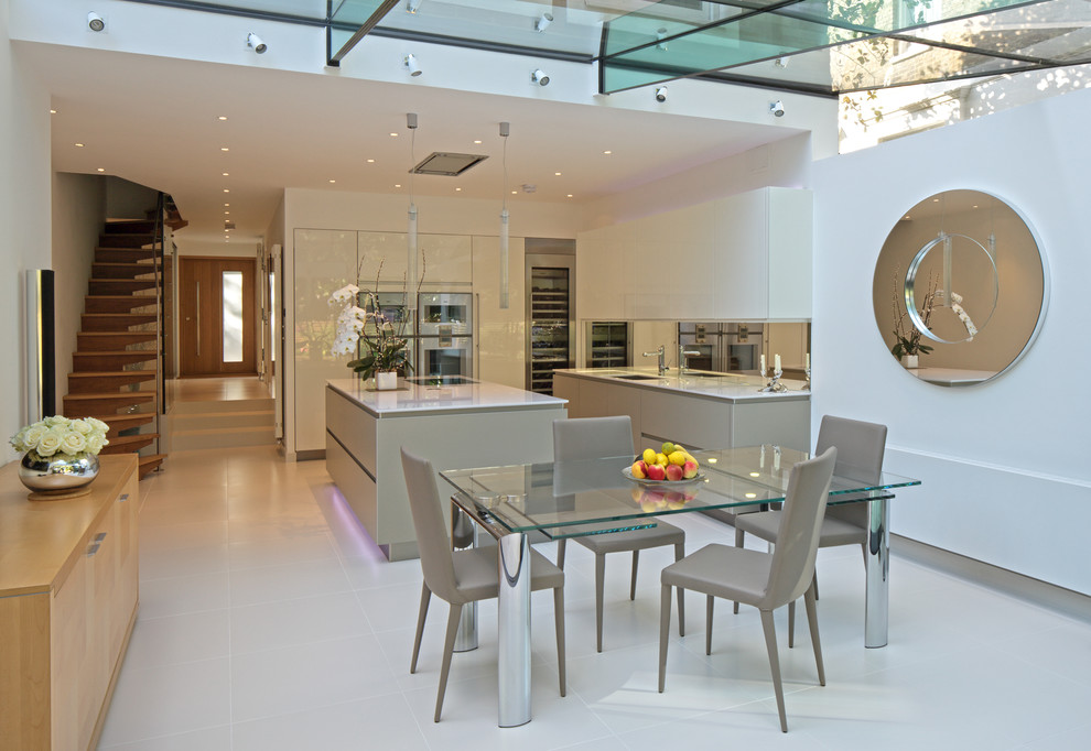 Inspiration for a large contemporary open plan dining in London with white walls and white floor.