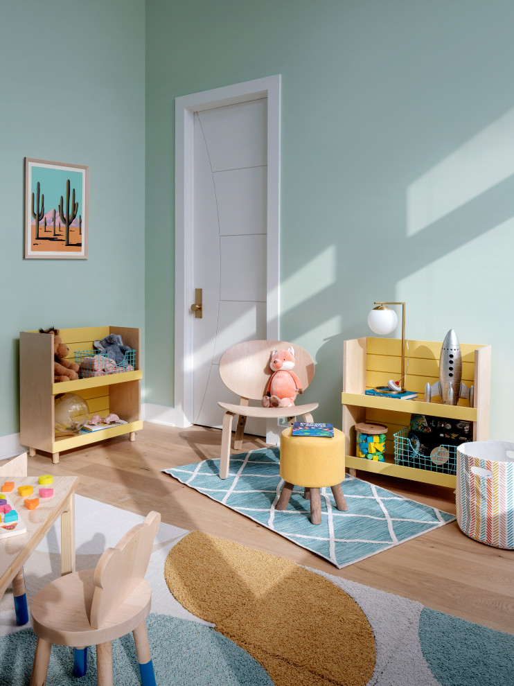 This is an example of a mid-sized midcentury kids' bedroom in Austin with green walls, medium hardwood floors and wallpaper.