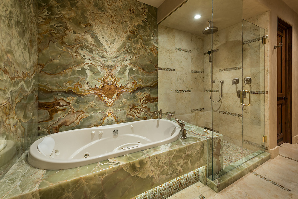 Large master bathroom in Other with a drop-in tub, a corner shower, flat-panel cabinets, light wood cabinets, beige tile, stone tile, beige walls, marble floors and a hinged shower door.