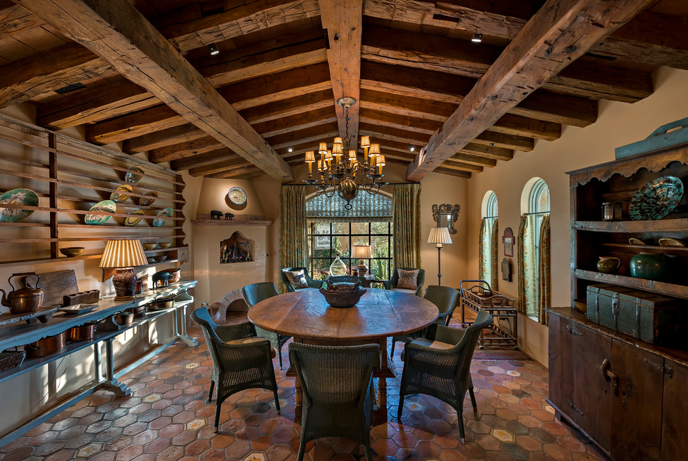 Country dining room in Phoenix with beige walls and terra-cotta floors.