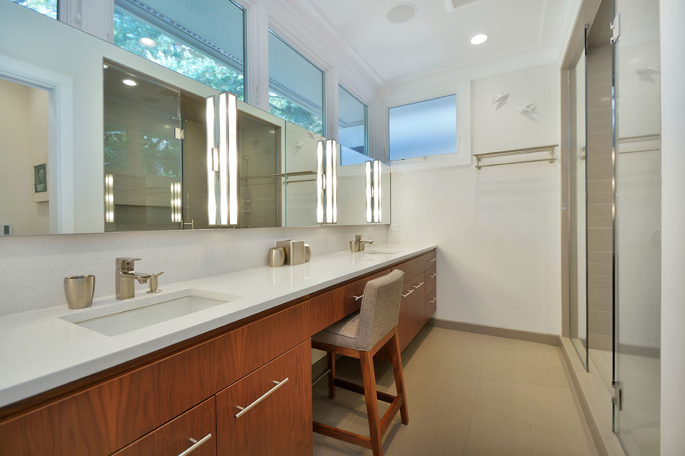 Photo of a mid-sized contemporary master bathroom in Chicago with an undermount sink, flat-panel cabinets, medium wood cabinets, engineered quartz benchtops, an alcove shower, beige tile, porcelain tile, white walls and porcelain floors.