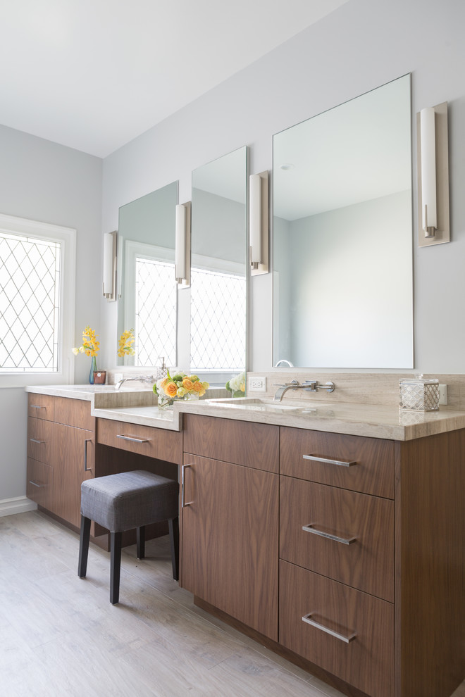 Large contemporary master bathroom in Los Angeles with flat-panel cabinets, medium wood cabinets, a freestanding tub, a corner shower, blue tile, grey walls, porcelain floors, an undermount sink and limestone benchtops.