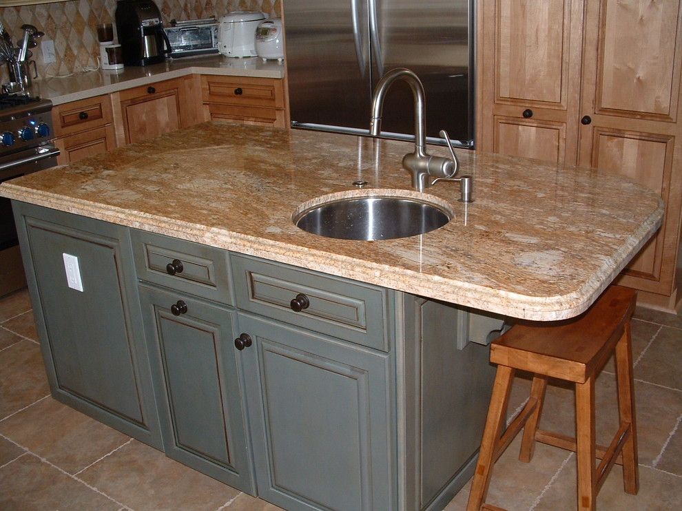 Eat-in kitchen - mid-sized transitional u-shaped travertine floor eat-in kitchen idea in Orange County with a farmhouse sink, shaker cabinets, yellow cabinets, quartz countertops, multicolored backsplash, stone tile backsplash, stainless steel appliances and an island