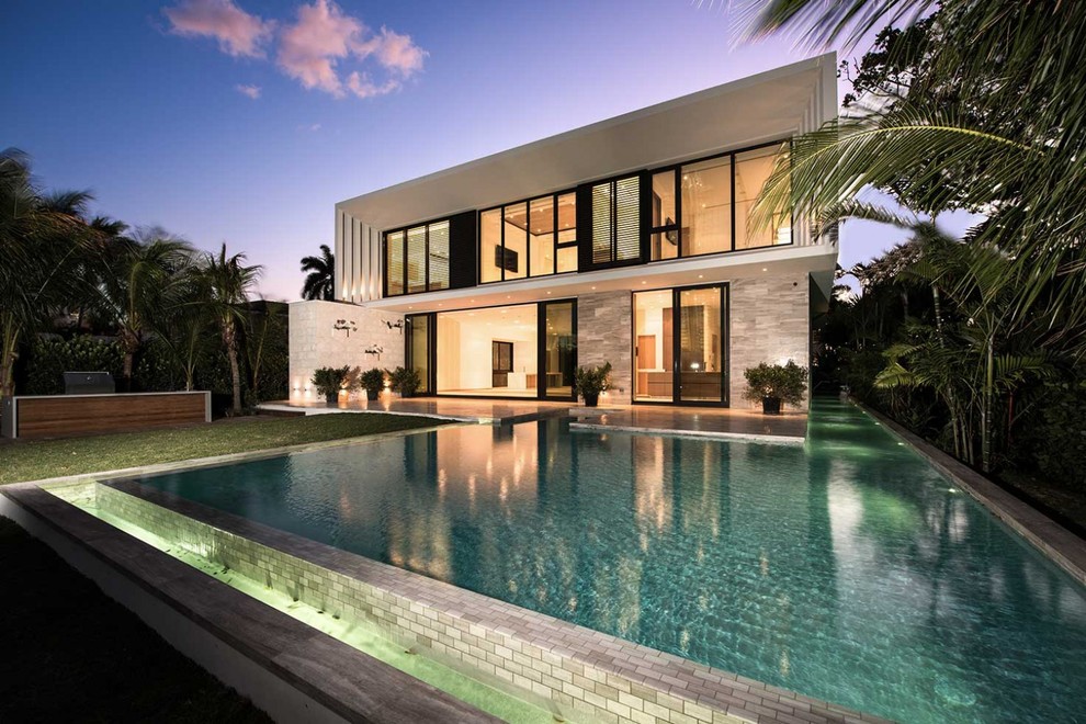 Contemporary backyard custom-shaped infinity pool in Miami.