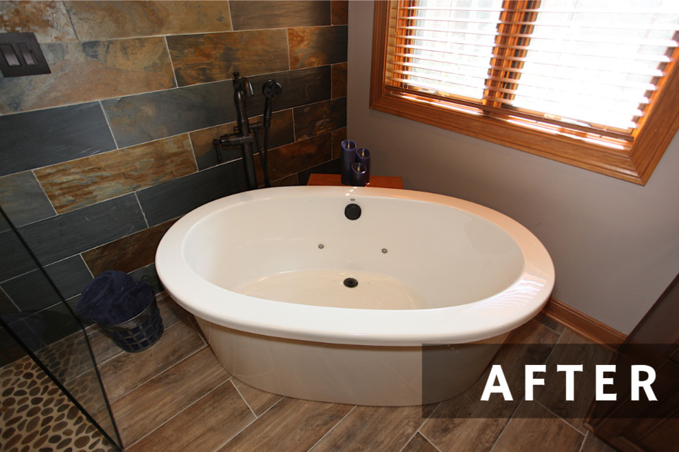 Freestanding bathtub - large rustic master slate tile brown floor freestanding bathtub idea in Indianapolis with brown cabinets, beige walls and an undermount sink