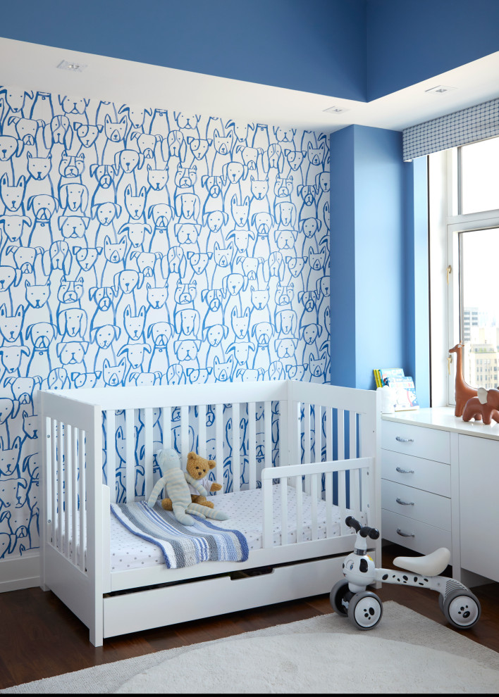 Photo of a medium sized traditional gender neutral nursery in Other with blue walls and a feature wall.