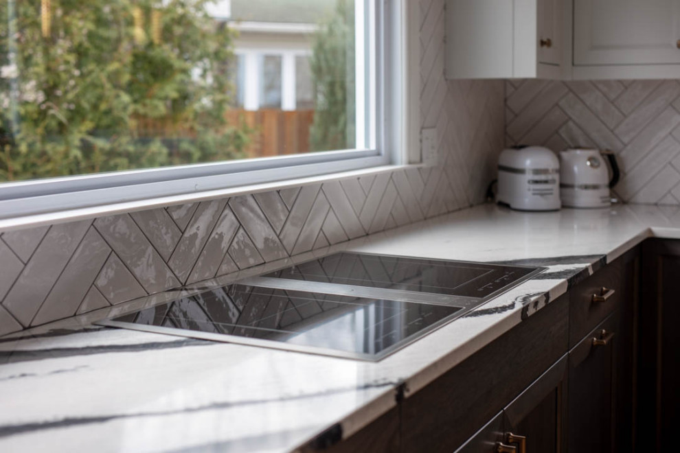 Inspiration for a transitional u-shaped light wood floor open concept kitchen remodel in Ottawa with a farmhouse sink, recessed-panel cabinets, dark wood cabinets, quartz countertops, white backsplash, porcelain backsplash, paneled appliances, a peninsula and black countertops
