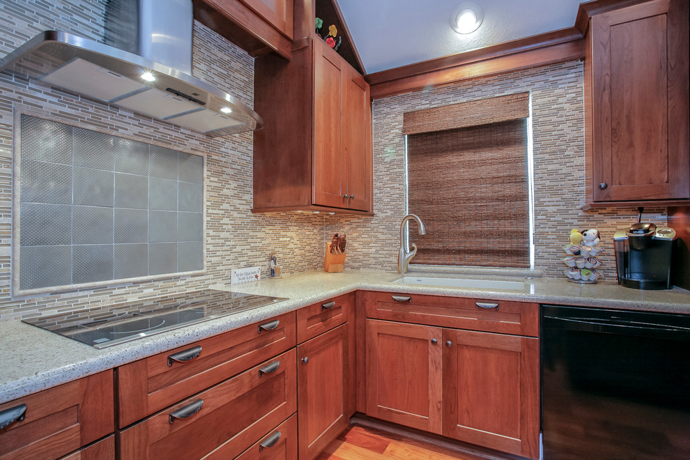Inspiration for a mid-sized modern l-shaped medium tone wood floor eat-in kitchen remodel in Houston with a drop-in sink, shaker cabinets, medium tone wood cabinets, quartz countertops, multicolored backsplash, mosaic tile backsplash, black appliances and an island