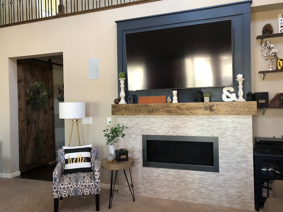 This is an example of a transitional family room in Denver with blue walls, a ribbon fireplace, a tile fireplace surround and a wall-mounted tv.