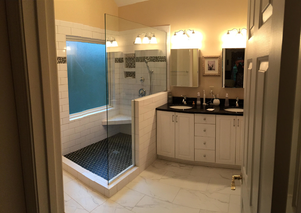 Inspiration for a mid-sized transitional master bathroom in Other with raised-panel cabinets, white cabinets, a corner shower, white tile, subway tile, yellow walls, marble floors, an undermount sink, engineered quartz benchtops, white floor, an open shower and black benchtops.
