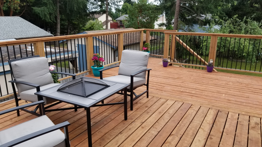 Mid-sized arts and crafts backyard second story mixed material railing deck photo with no cover