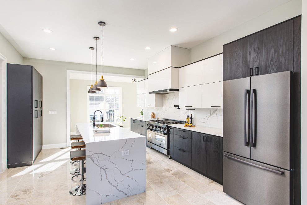 Open concept kitchen - large modern galley marble floor and beige floor open concept kitchen idea in DC Metro with a drop-in sink, flat-panel cabinets, white cabinets, quartz countertops, white backsplash, quartz backsplash, black appliances, an island and white countertops