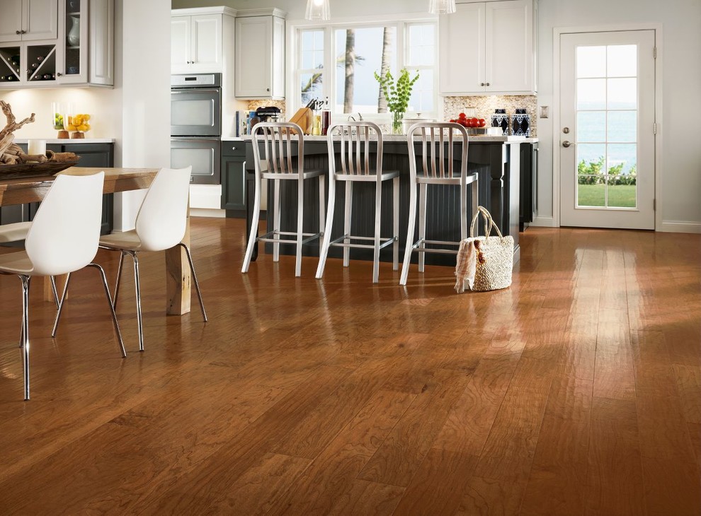 Large transitional single-wall medium tone wood floor and brown floor eat-in kitchen photo with shaker cabinets, white cabinets, quartz countertops, beige backsplash, matchstick tile backsplash, stainless steel appliances, an island and an undermount sink