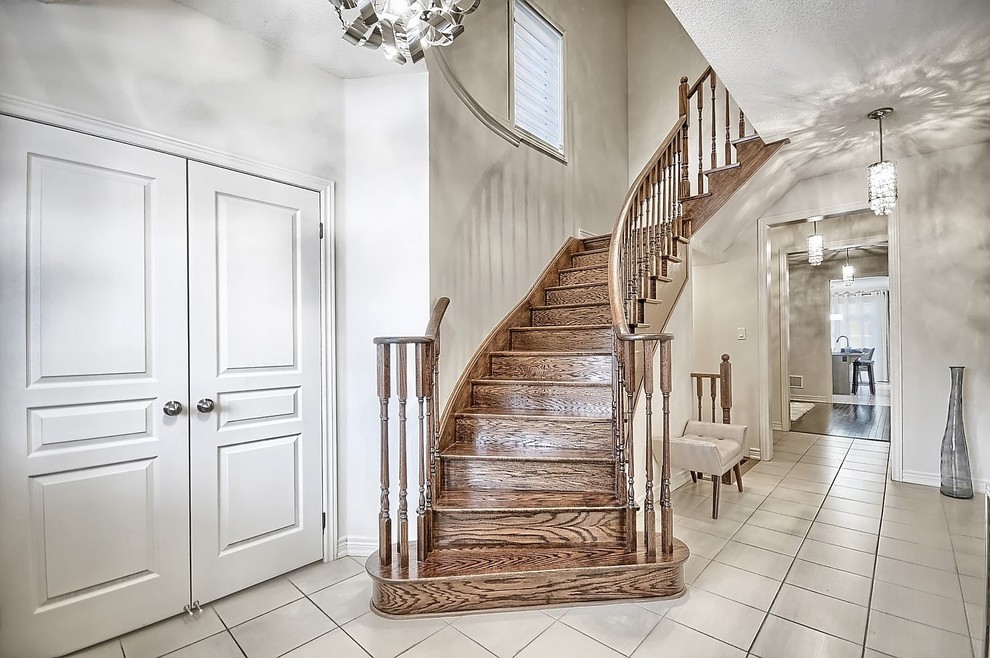 Mid-sized transitional ceramic tile and beige floor foyer photo in Toronto with beige walls and a white front door
