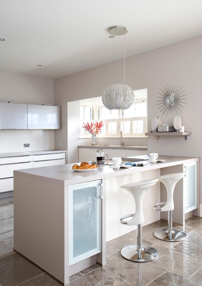 Photo of a contemporary u-shaped kitchen in Dublin with an undermount sink, flat-panel cabinets, white cabinets and a peninsula.