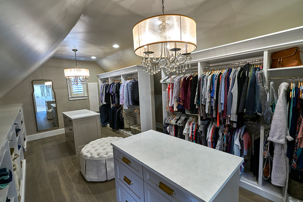 Design ideas for a large traditional gender-neutral walk-in wardrobe in Atlanta with open cabinets, white cabinets, light hardwood floors and brown floor.